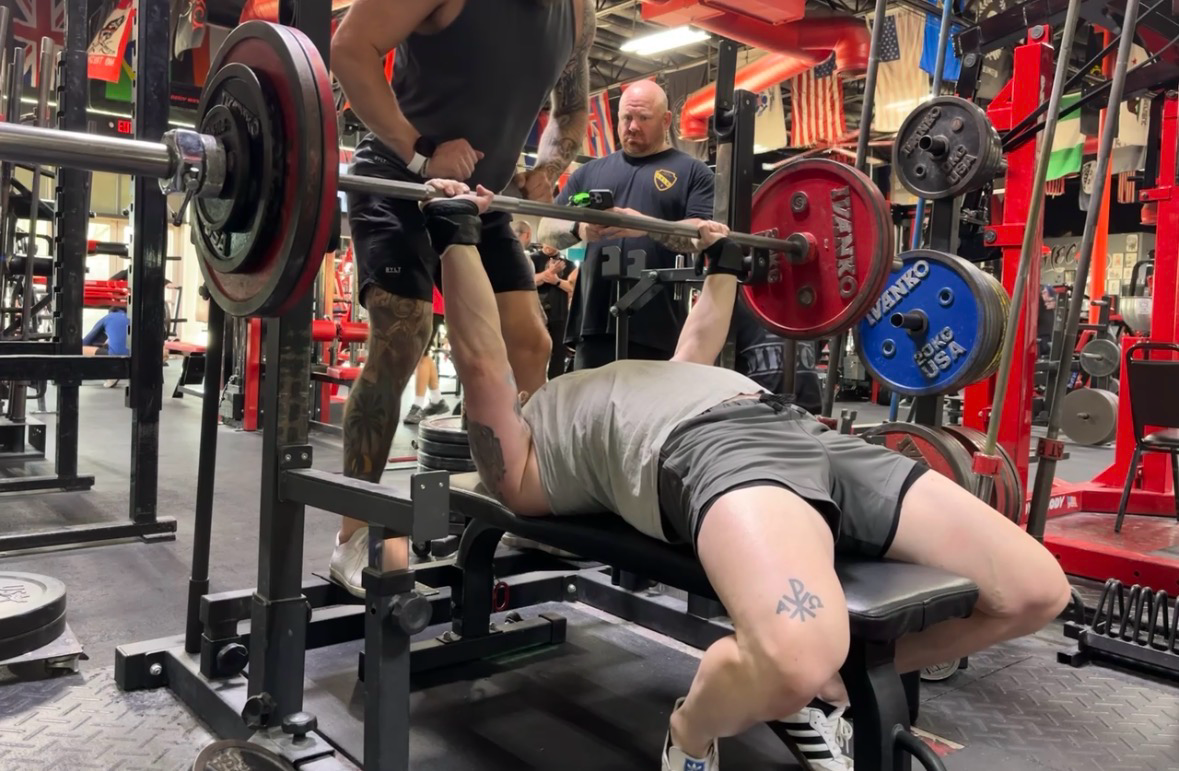 Bobby Lawson coaching a lifter through a bench press